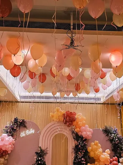 Another angle of the dreamy baby shower setup. The warm lighting combined with the soft colors of the balloons and the elegant backdrop created a truly magical and intimate atmosphere.
