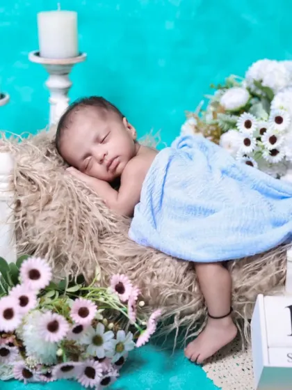 Marking the date of this precious memory. This setup includes a calendar block alongside the sleeping newborn, making it a perfect birth announcement photo.