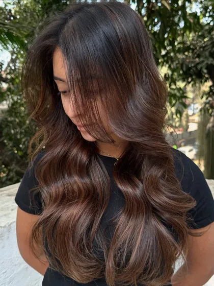 A portrait of the client with her new 'Hazelnut Chocolate Truffle' hair.