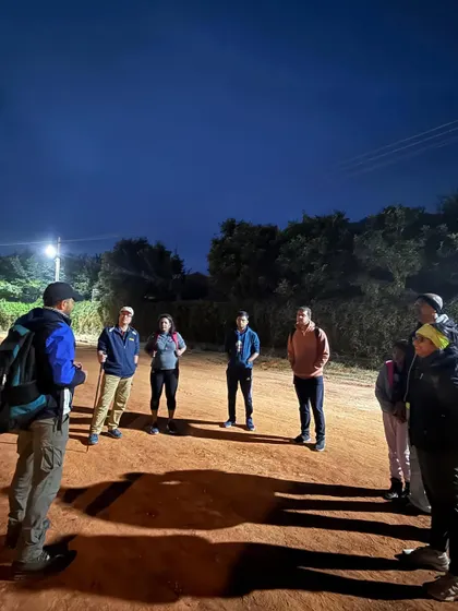 A night briefing before the Makalidurga trek. Safety is paramount, and we ensure everyone is prepared, especially for sunrise or night treks.