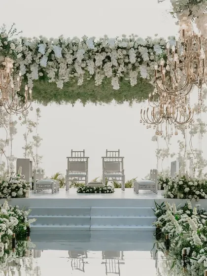 A closer look at the dreamy all-white mandap setup. The mirrored aisle and lush florals created a pathway to heaven.