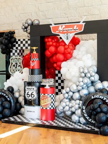 I bring high-octane fun with themes like Disney's Cars. This setup features a bold color scheme, a checkered floor, and iconic elements like the Route 66 sign and Rust-eze branding, creating a perfect racetrack atmosphere for any car enthusiast's birthday party.