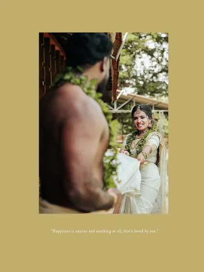 A playful moment between a bride and groom in traditional Kerala wedding attire.