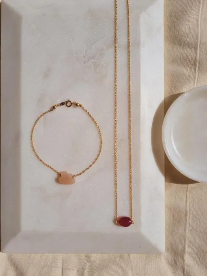 To attract more money, wear Ruby. This image shows my 'ámya' Ruby Baati choker alongside a Peach Moonstone cloud bracelet for luck and abundance.