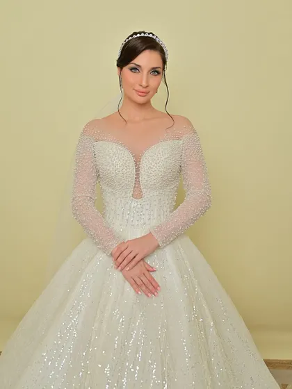 A full-length view of the bride in her sparkling white gown, a perfect vision of bridal elegance.