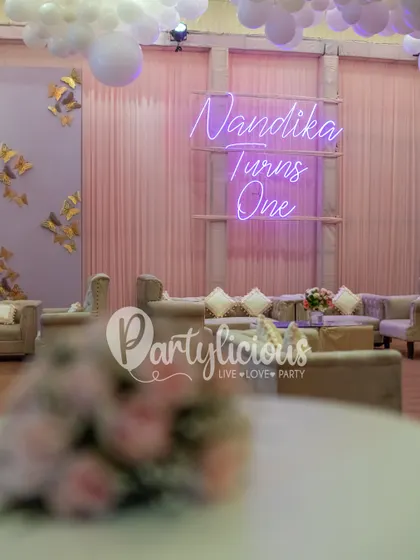 A beautiful shot of the event space, with the 'Nandika Turns One' neon sign glowing in the background.