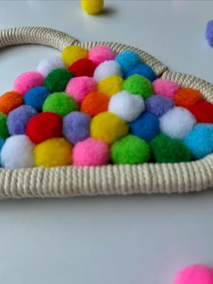 A close-up of the colorful pompoms inside the macrame cloud decor. The variety of colors makes it a vibrant and eye-catching piece.
