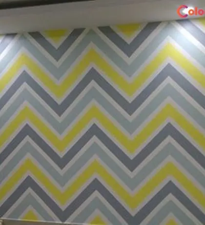 This zigzag or chevron stencil pattern uses a playful color palette of yellow, grey, and blue. It's a fun and modern design that can bring a lot of energy to a bedroom or playroom.