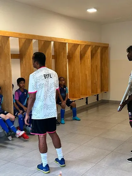 A pre-training pep talk inside the changing room, where the coach sets the tone for the session.