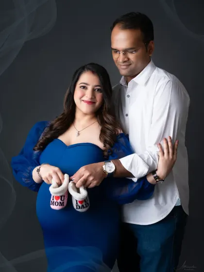 A classic couple's portrait with a sweet prop. The "I love Mom" and "I love Dad" baby shoes are a perfect way to announce your excitement.