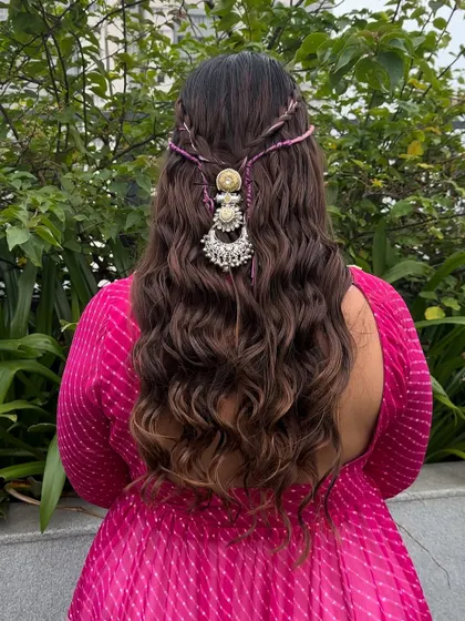 Embrace festive elegance with this half up, half down hairstyle, adorned with a statement silver accessory for a touch of traditional charm.