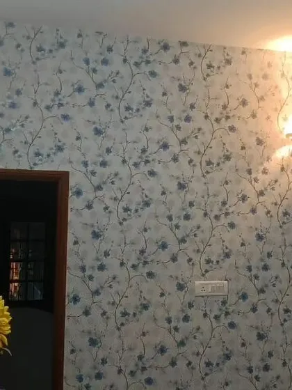 A delicate blue floral vine wallpaper adds a touch of classic elegance to this room. The pattern is subtle enough to be used on all walls without overwhelming the space.