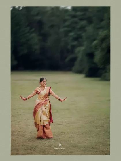 The bride in a joyful, dancing pose in an open field, her happiness radiating from the image.