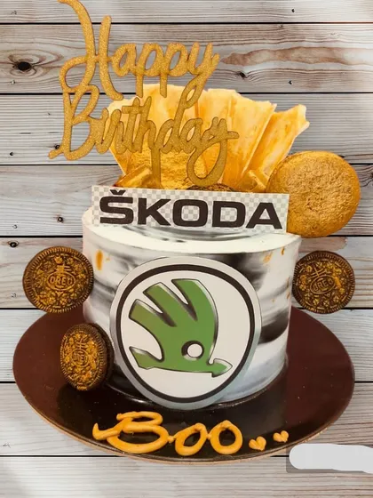 A cake for a Škoda car enthusiast. This design features the brand's logo and a "Happy Birthday" topper, combining a hobby with a celebration.