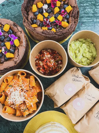 A snapshot of our daily orders ready for delivery. This includes my flourless chocolate cakes, Mexican bowls, and fresh pasta, all made from scratch.