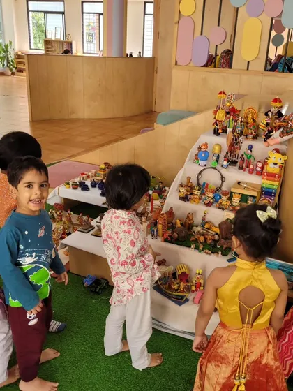 Children admire the 'Golu' display, learning about the stories and traditions of Navratri and Dussehra.