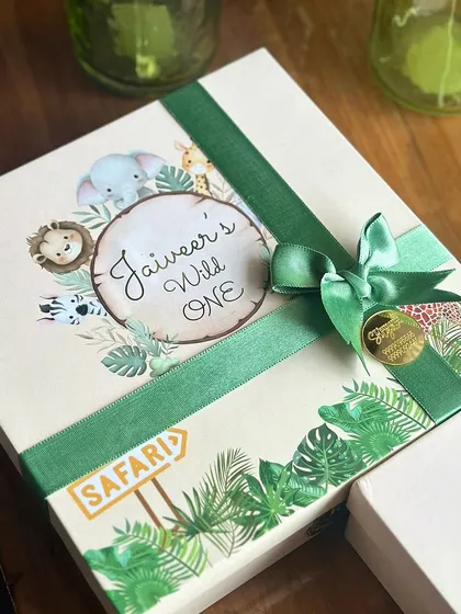 The lid of our jungle themed hamper box, featuring a personalized "Jaiveer's Wild One" design with cute safari animals.