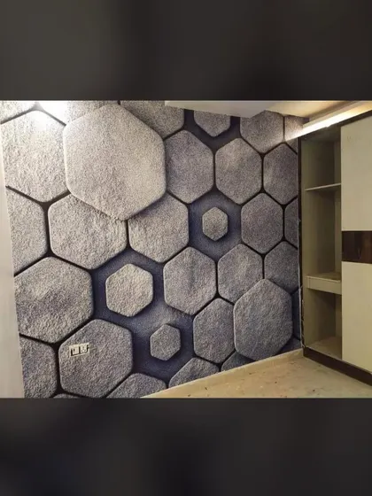 A 3D wallpaper with a honeycomb stone pattern. The textured look gives the wall a rugged yet modern feel, perfect for a feature wall in a living area.