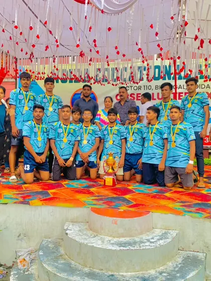 The full team celebrating their first-place victory at the CBSE cluster tournament on the winner's stage.
