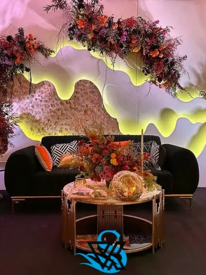 Another view of the modern lounge setup with the custom wavy backdrop, showing the full seating arrangement.