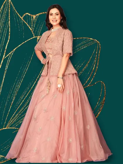 For a modern twist on traditional wear, I offer indo-western pieces like this elegant lehenga paired with a chic jacket. It's the perfect fusion of contemporary style and ethnic grace.