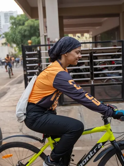 A side view of a cyclist, showcasing the custom jersey and the determination of our participants.