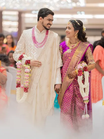 A beautiful shot of a Maharashtrian couple walking through a misty aisle after their ceremony, creating a dreamy and romantic atmosphere.