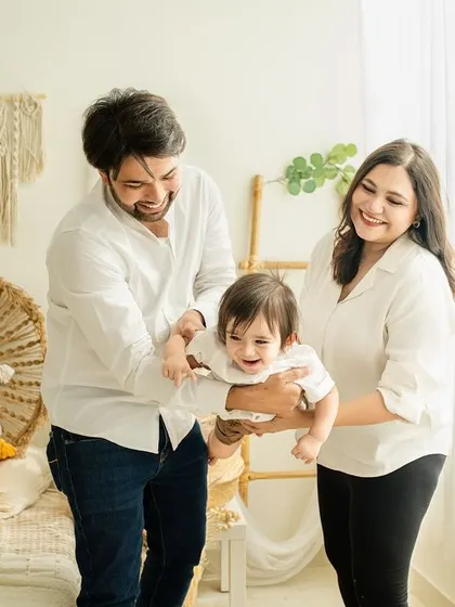 The simple joy of lifting your baby in the air. This action shot is filled with movement and laughter, perfectly capturing the energy of this young family.