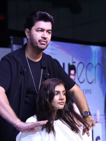 A close-up shot of me explaining a technique during a live hair show. Education is key to elevating our industry.