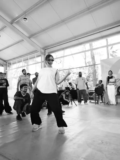A black and white shot from the Spectra battles, highlighting the cool confidence of a performer in the cypher.