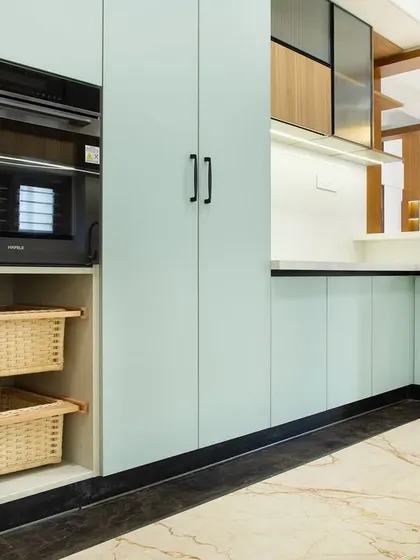 This angle highlights the smart storage solutions, including open baskets for vegetables and a dedicated unit for the microwave oven, keeping the countertop clutter-free.