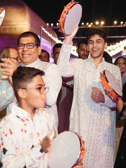 Guests enjoying the interactive element of tambourines during the Sufi Night, adding to the festive and musical atmosphere.