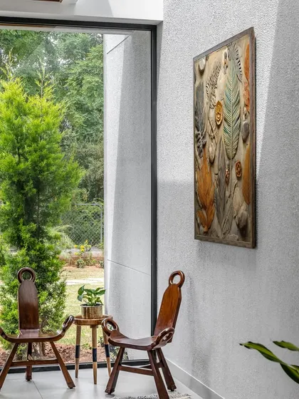 Natural light brings a space to life. Here, a large window frames the outdoor greenery like a living painting, blurring the line between inside and out. This connection to nature is a key element of our biophilic design approach.