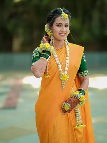 A radiant bride during her Haldi ceremony. I love capturing these solo portraits, focusing on the joy and anticipation of the bride, adorned in traditional floral jewelry and glowing with happiness.