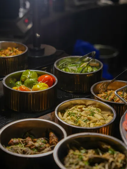 A selection of pasta salads and other cold preparations in stylish metal bowls. Our buffet spreads are designed for both visual appeal and practical, efficient service.