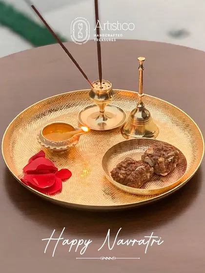 Happy Navratri. This image captures the essence of festive rituals with our chatai-textured gold finish pooja thali, complete with a diya, incense, and prasad.