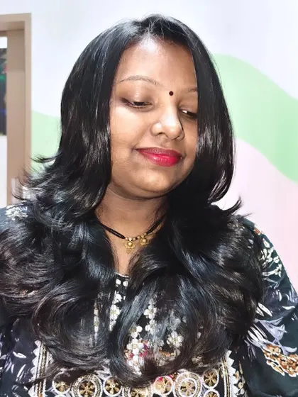 This client looks radiant with her new layered haircut and a touch of red lipstick.