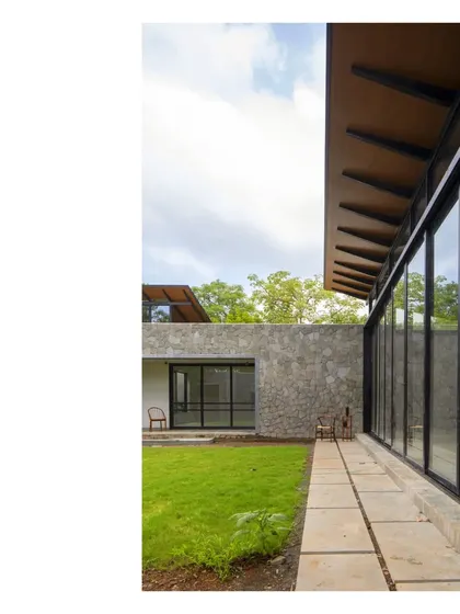 Nestled in a grove in Alibaug, this home delivers an alfresco living experience under tree canopies. Lounging, dining, and reading happen outdoors, cradled in the spirit of nature. Nothing more, nothing less.