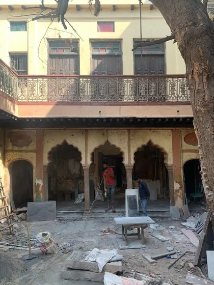 Laying the new stone floor in the courtyard, a crucial phase of the project that required precision and skilled craftsmanship.