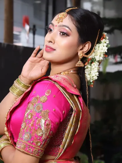 A close-up profile of this South Indian bride, showing the seamless blend of the makeup and the intricate details of her embroidered blouse.