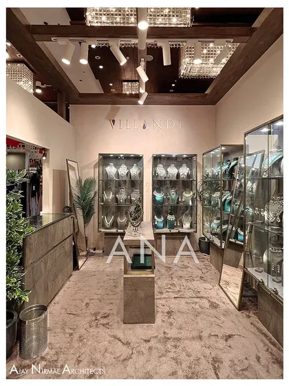 An interior view of the Villandi '22 stall, showing the arrangement of the custom jewellery display cases. The plush carpeting and focused track lighting create an intimate and high-end retail atmosphere.