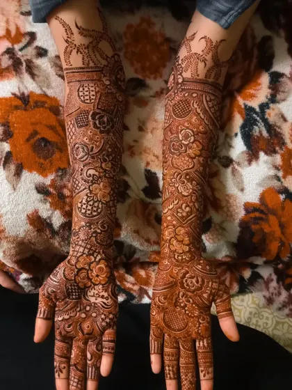 A full bridal mehndi design with intricate patterns covering the hands and arms. The design includes traditional motifs for a timeless and elegant feel.