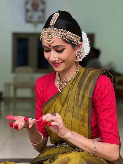 Just dancer things. A candid moment of applying Altha, the traditional red dye for hands and feet, which is an essential part of the pre-performance ritual.