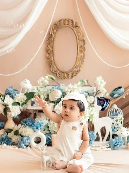 A dreamy setup with soft blue and white florals. This angelic theme is perfect for capturing the innocence and sweetness of a baby's milestone session.