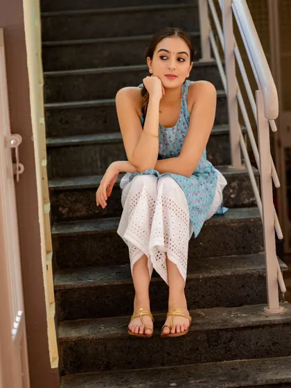 A quiet moment of waiting, captured on a staircase. The soft, ambient light creates a gentle and thoughtful mood.