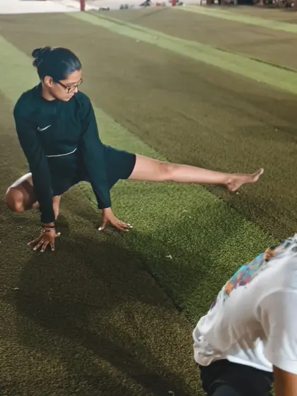A student works on her flexibility. We incorporate a variety of stretches to target all the major muscle groups used in Taekwondo.