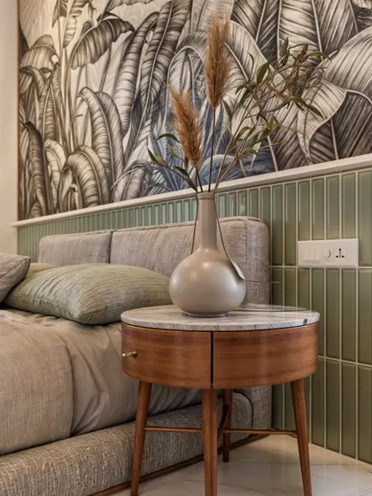 A close-up of the bedside table in the Campan Valley Villa master bedroom, showing the beautiful combination of wood, marble, and green tiles.