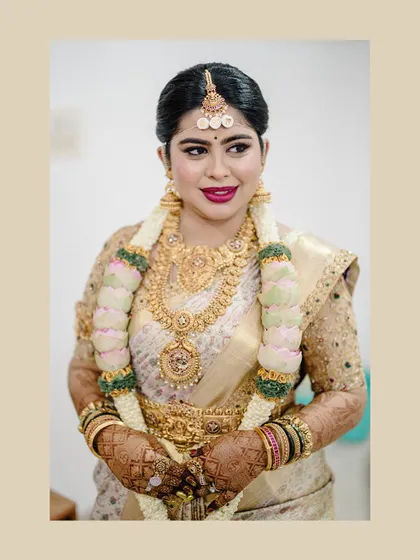 A close-up portrait of the bride Diana, focusing on her happy expression and the intricate details of her custom blouse and jewelry.