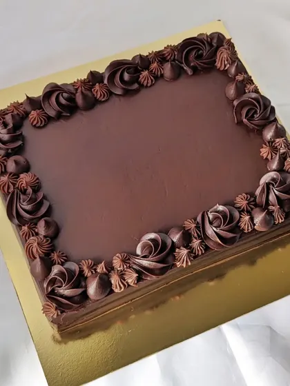Sheet cakes are perfect for larger gatherings. This dark chocolate sheet cake is easy to cut and serve, and the piped rosettes add a touch of elegance.