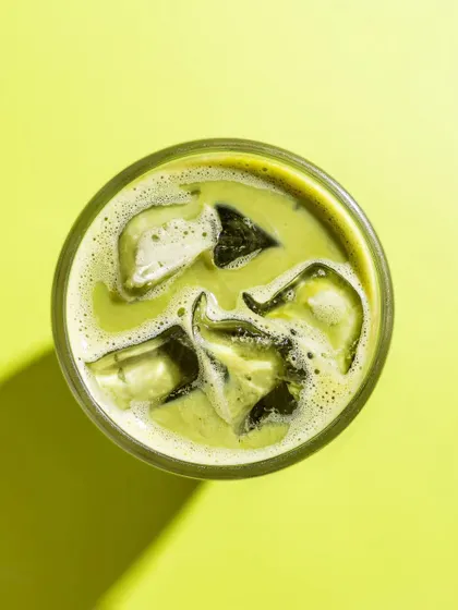 A top-down shot of an iced matcha latte from Mokai. The bright, monochromatic background creates a bold, graphic image that is perfect for social media.